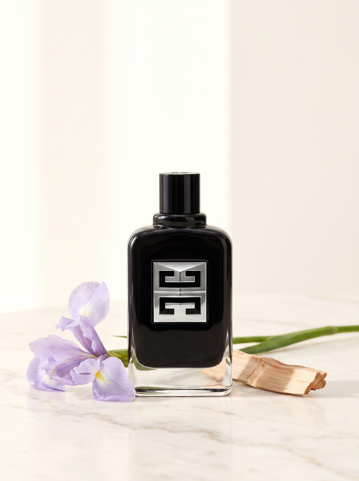 Givenchy Gentleman Society Eau de Parfum 100 ml - schwarzer Flakon auf hellem Marmor mit Iris und Zedernholz