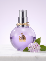 Lanvin Eclat d Arpege Eau de Parfum 100 ml - violetter Kugelflakon auf hellem Marmor mit Fliederblueten