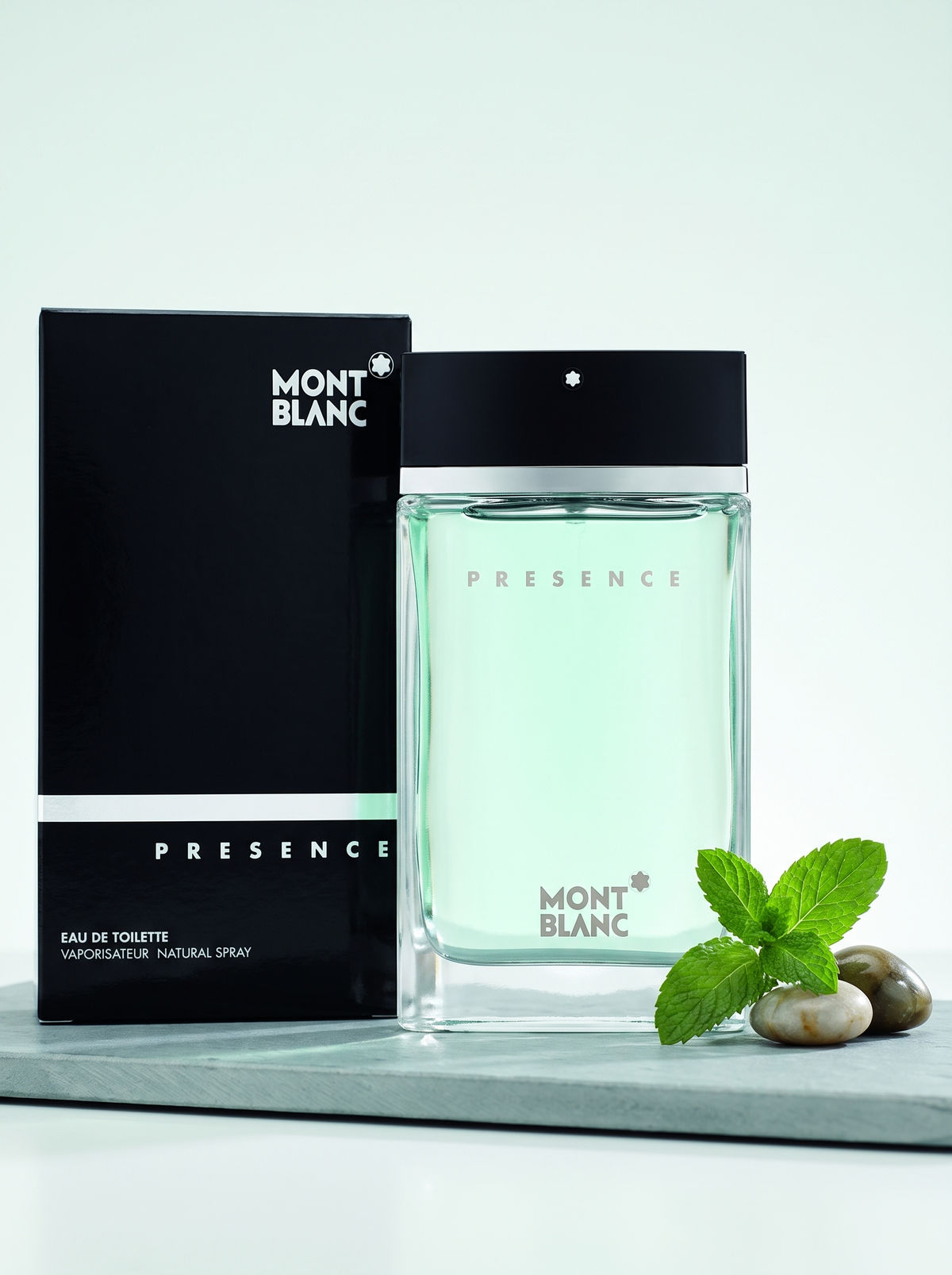 Montblanc Presence Eau de Toilette 75 ml - Flakon mit Verpackung auf Schiefer mit Minze