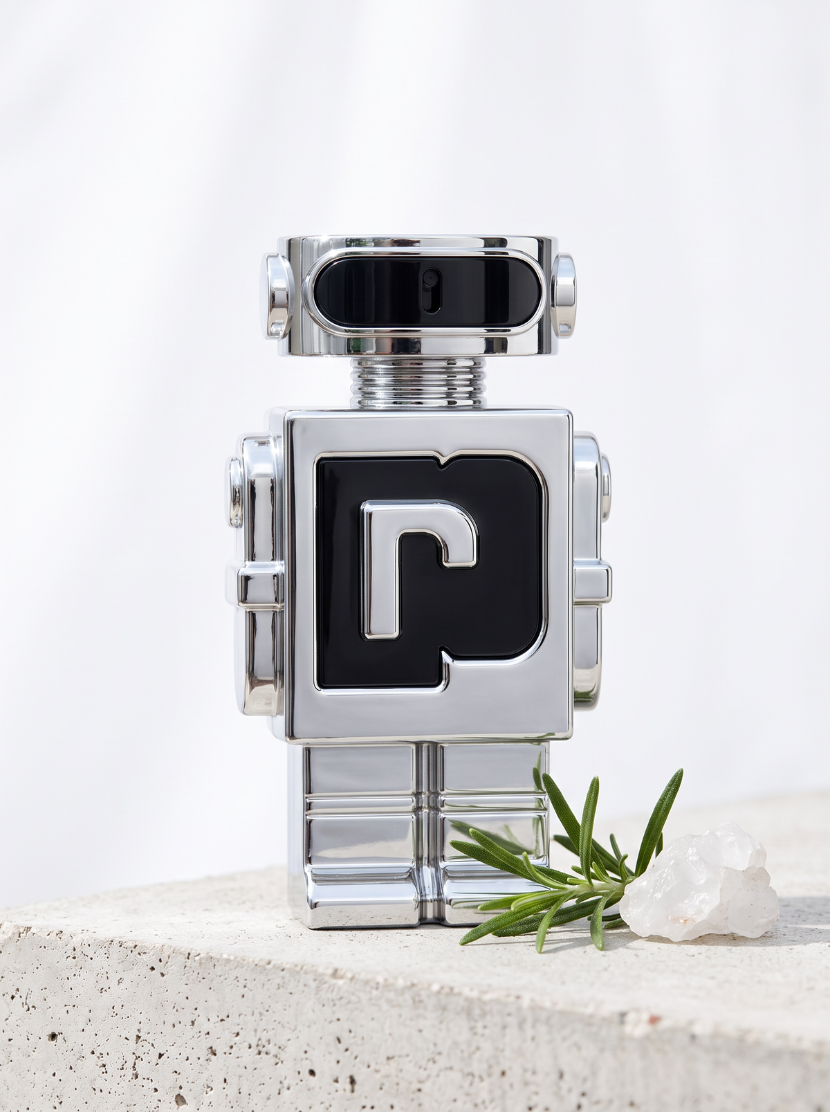 Rabanne Phantom Eau de Toilette 50 ml - Roboter-Flakon aus Chrom auf hellem Beton mit Rosmarin