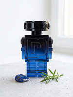 Rabanne Phantom Intense Eau de Parfum 100 ml - blauer Roboter-Flakon auf hellem Beton mit Lapislazuli und Rosmarin