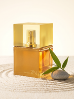 Shiseido Zen Eau de Parfum 30 ml - goldener Wuerfelflakon auf hellem Sand mit Bambus und Kiesel